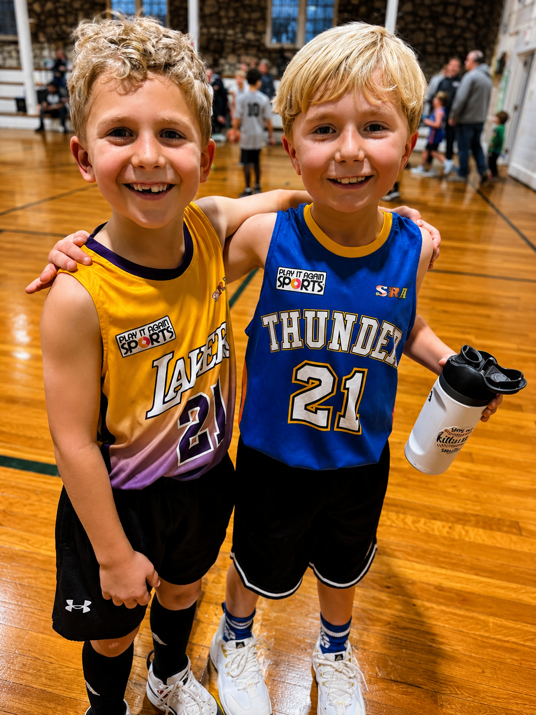 Two SRA basketball players smiling together