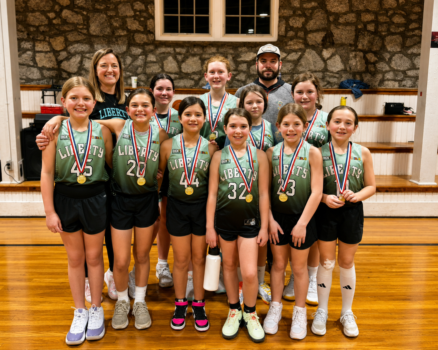 SRA girls basketball team celebrating