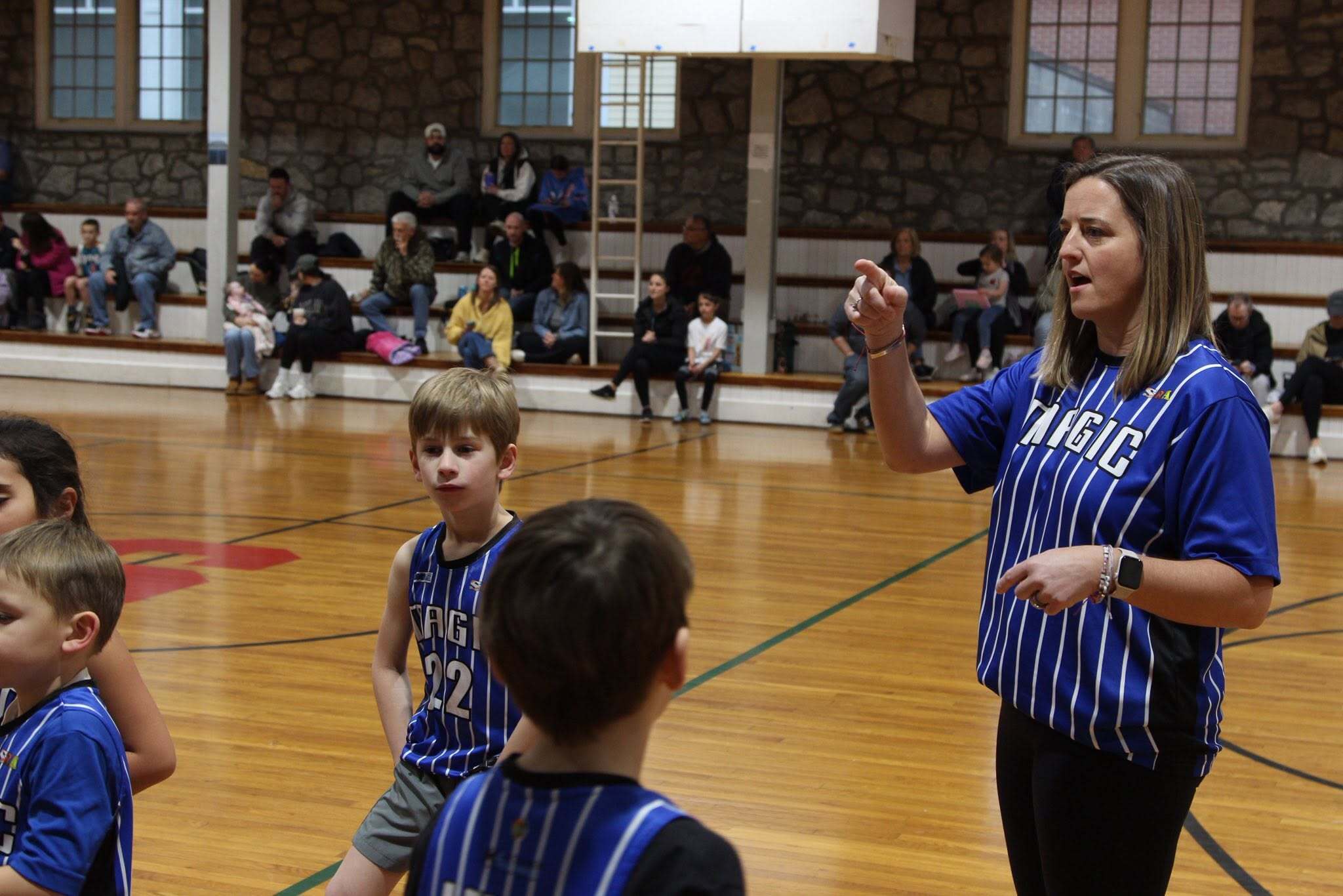 SRA basketball coach working with young athletes